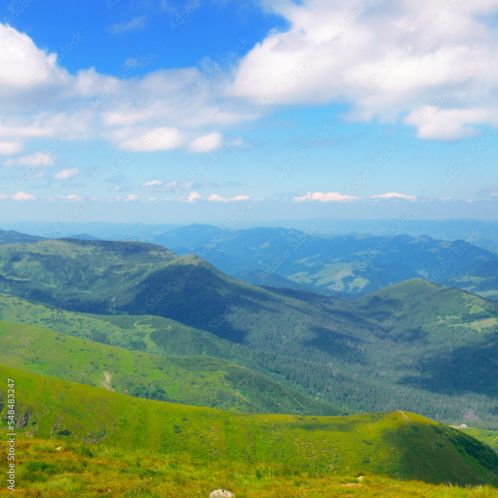 Carpathian mountains, peaks, mountain valleys and beautiful cloudy sky.