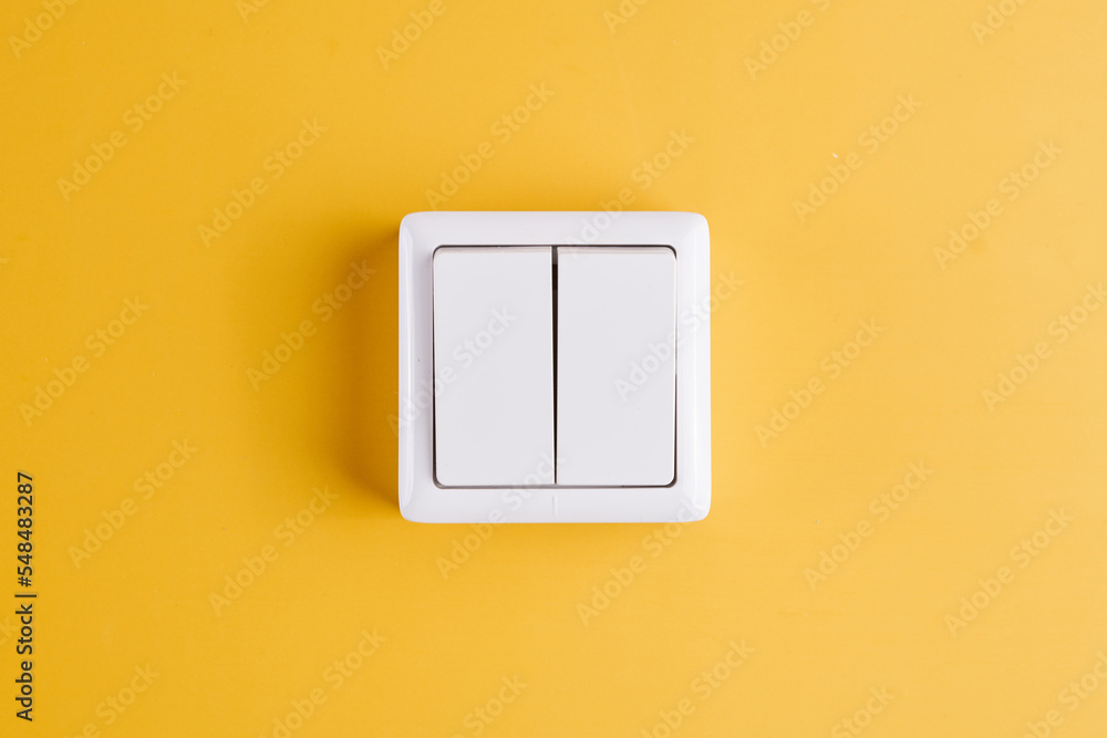 White double light switch isolated on yellow background. On/Off White double light switch isolated on yellow background. On/Off