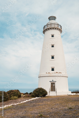 Cape Willoughby active lighthouse viewed against blue sky with clouds on a day, Kangaroo Island, South Australia