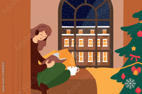 Girl reading book. Listen audiobook Christmas tree