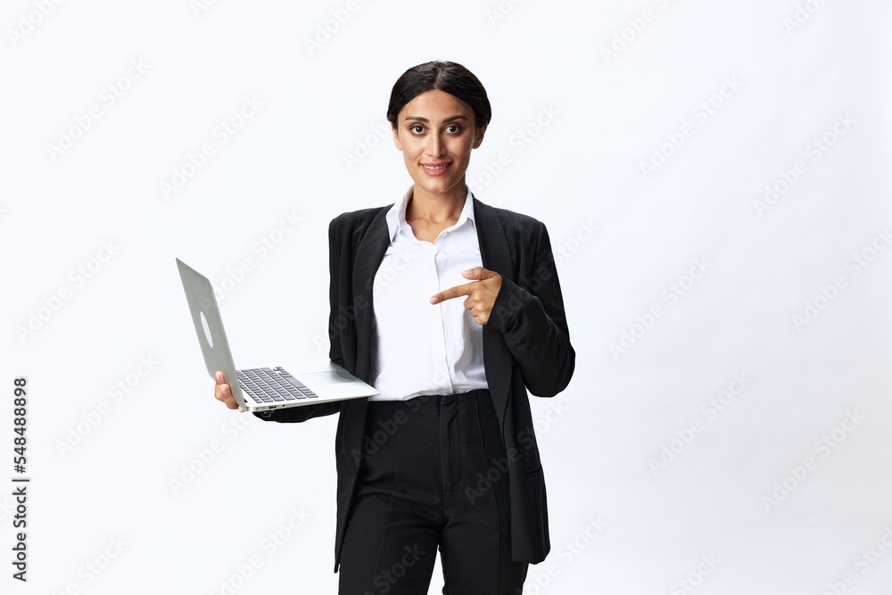 Business woman with laptop in hand in black business suit shows signals gestures and emotions on white background, freelancer job online training