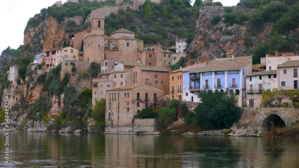 View of MIRAVET in Catalonia, a beautiful town on the banks of the Ebro river, in the upper part is the Castle of the Templars,a good example of religious and military architecture throughout the West View of MIRAVET in Catalonia, a beautiful town on the banks of the Ebro river, in the upper part is the Castle of the Templars,a good example of religious and military architecture throughout the West
