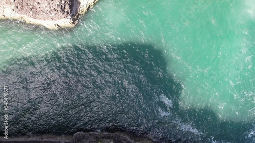 Crawton Waterfall (cascade), Aberdeenshire, Scotlland by drone (aerial view) situated on the Aberdeenshire coast, former fishing village now occupied by seabirds (kittiwakes, razorbills). photo