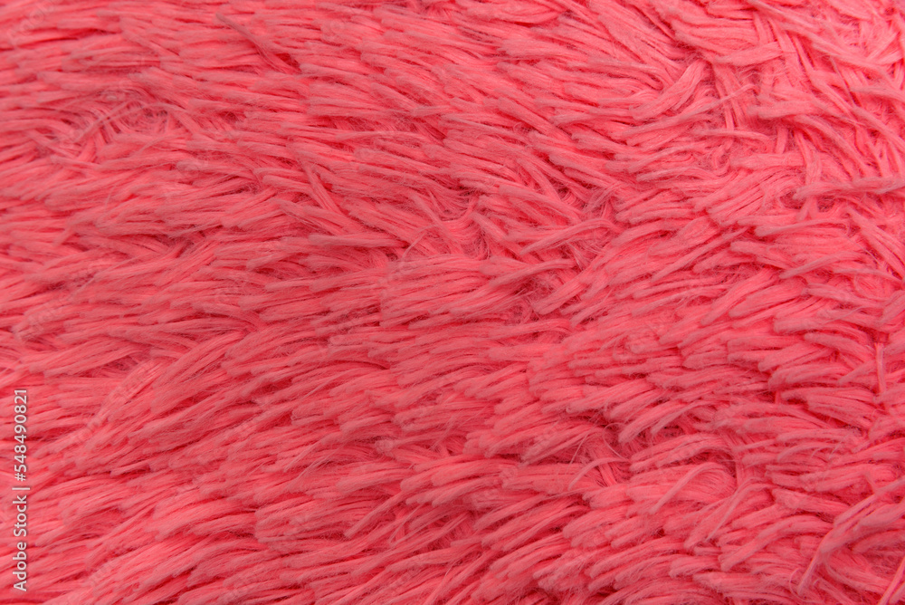 Fototapeta premium Texture bright pink faux fur close-up. Top view. Fur product as background. Trendy neon color