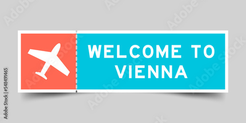 Orange and blue color ticket with plane icon and word welcome to vienna on gray background