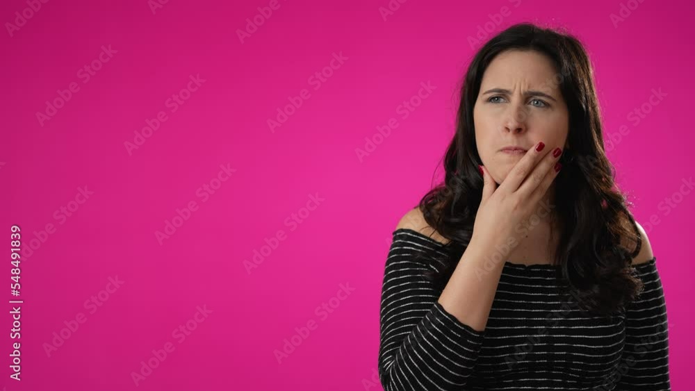 Off center portrait of thinking, smart puzzled pensive young hipster woman 20s looks around thinks comes up with ideas raised finger thumbs up isolated on pink background studio portrait copy space Off center portrait of thinking, smart puzzled pensive young hipster woman 20s looks around thinks comes up with ideas raised finger thumbs up isolated on pink background studio portrait copy space
