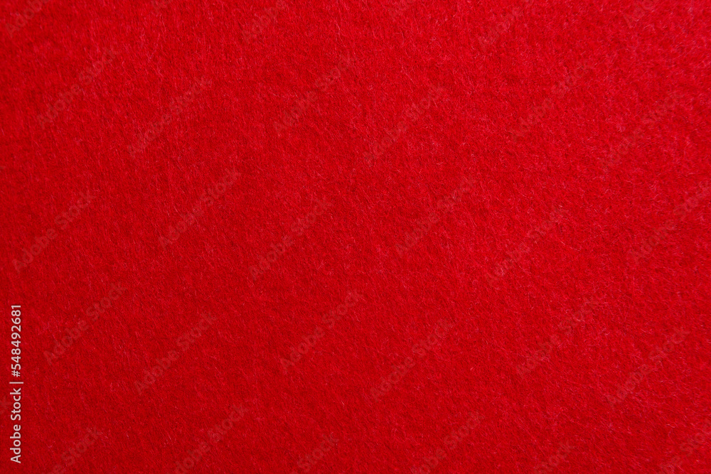 Red texture velour or felt cloth close-up. Natural or artificial sewing material. Fabric as background for design. Red texture velour or felt cloth close-up. Natural or artificial sewing material. Fabric as background for design.