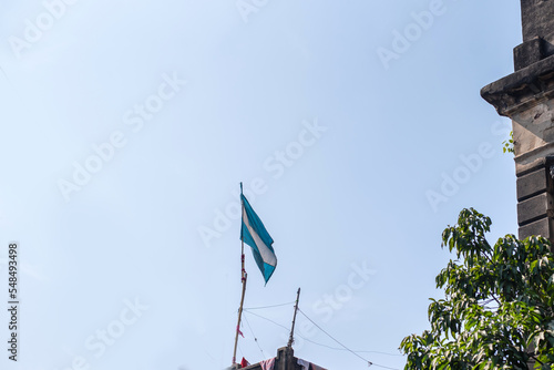 Argentina flag is flying in a blue sky