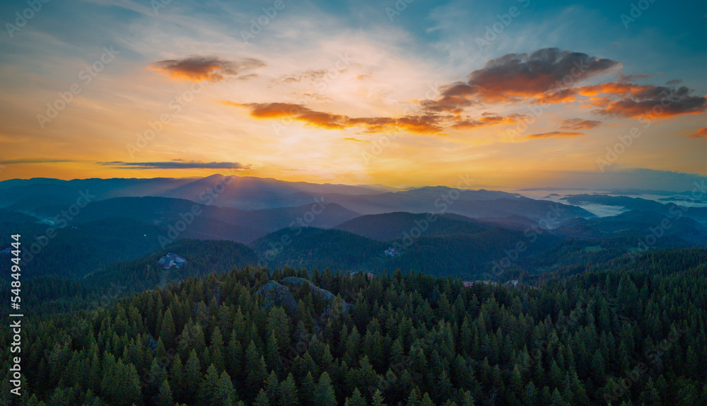Naklejka premium Valley of Balkan mountains with fog, sunny clouds and forests. Village Pamporovo. Panorama, top view