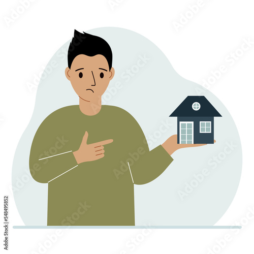 A man holds a small house in his palm. Concepts of inheritance, real estate transfer, mortgage, credit, loan or house purchase.