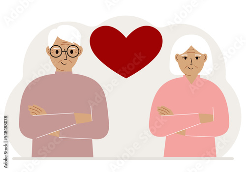 Happy old man and old woman next to a big red heart. Love.