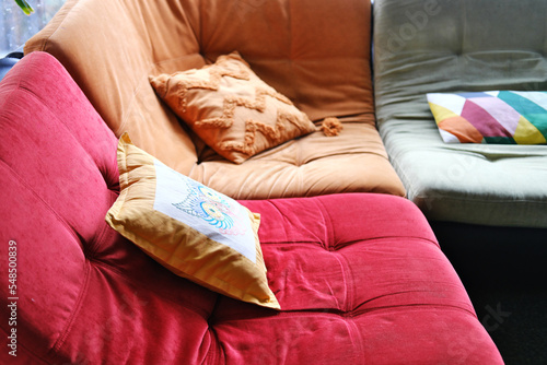 Multi-colored corner sofa in the interior of the room