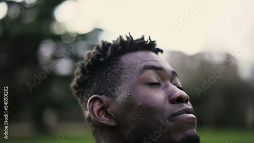 Young black man closing and opening eyes in meditation and contemplation. African person taking a deep breath2