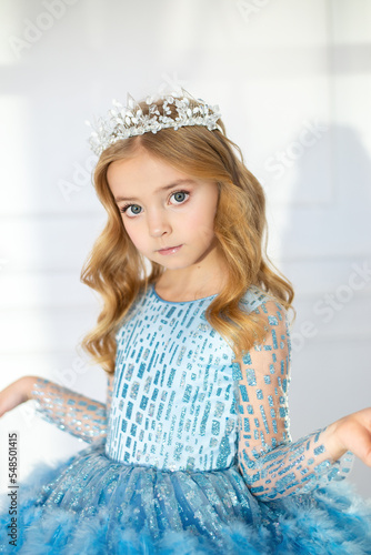 A beautiful little girl in a tiara, a cute princess. Baby with hair and makeup, baby cosmetics