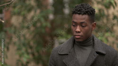 Thoughtful black man face looking at sky smiling