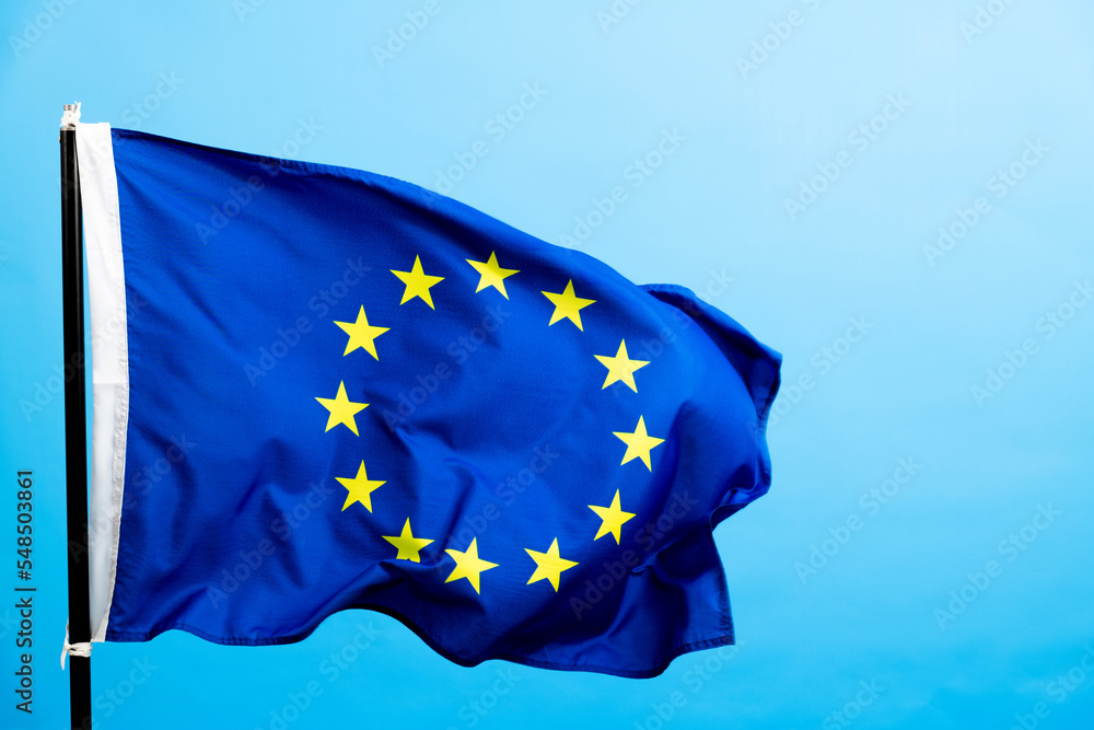 European Union Flag waving on blue background European Union Flag waving on blue background