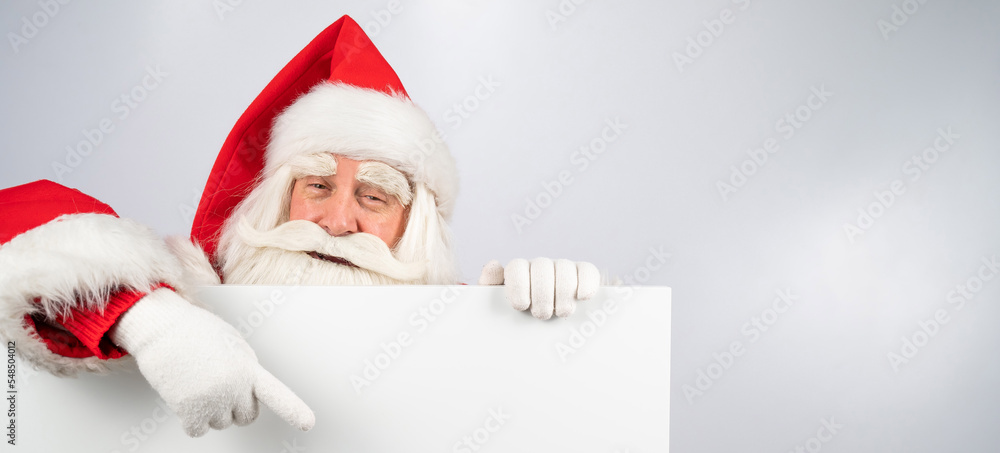 Santa Claus points to an empty white space. Promotional offer for Christmas. Santa Claus points to an empty white space. Promotional offer for Christmas.