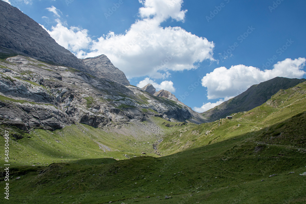 Picturesque view of the Pyrenees landscape with green meadows and mountains during the day. summer trip in the mountains,
