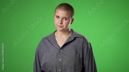 Portrait of angry frustrated despair upset portrait of gender fluid non binary young woman 20s isolated isolated on green screen background with copy space photo