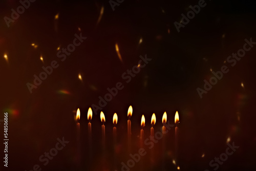 Religious image of Jewish holiday Hanukkah with candles of menorah with sparks from the fire in the air