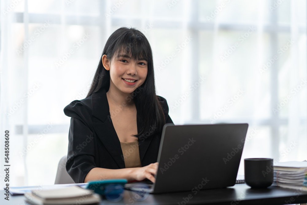 Business asian woman working on laptop computer managing her business in workplace, doing calculator planning document analyzing the financial report, business plan investment, finance analysis. Business asian woman working on laptop computer managing her business in workplace, doing calculator planning document analyzing the financial report, business plan investment, finance analysis.