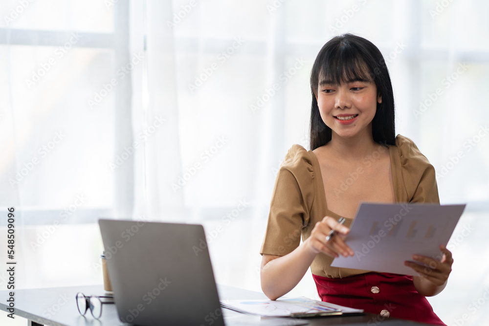Asian Businesswoman working on laptop at her desk at the office. Asian Businesswoman working on laptop at her desk at the office.