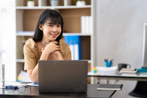 Asian Businesswoman working on laptop at her desk at the office.