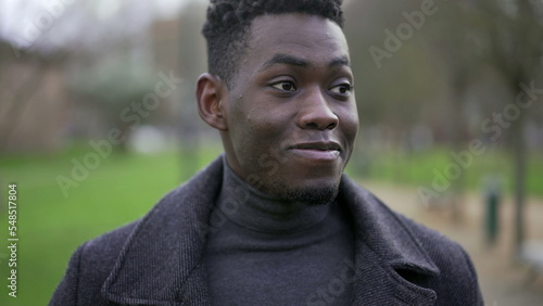 Young black man walking outside in nature during winter season