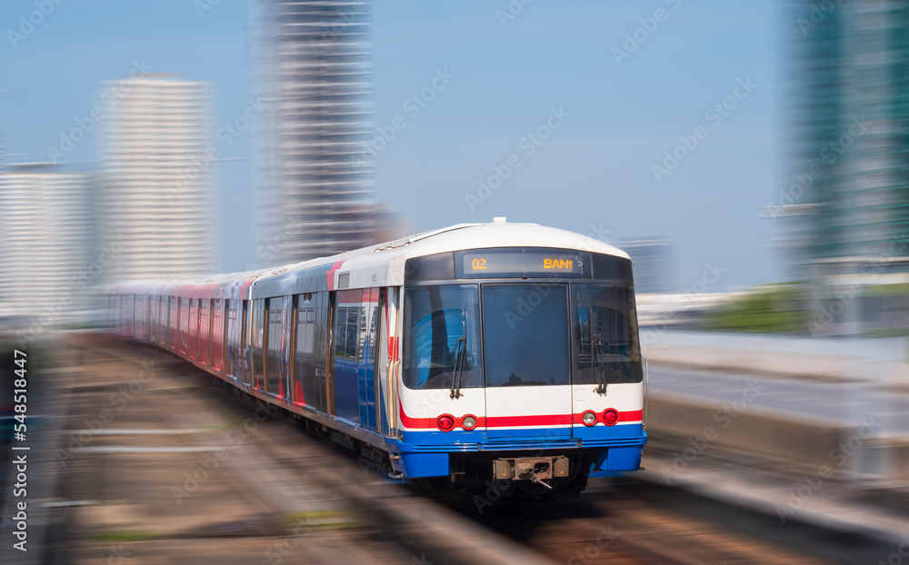 Motion blur of Sky train moving on elevated railway in downtown city at Bangkok, Thailand