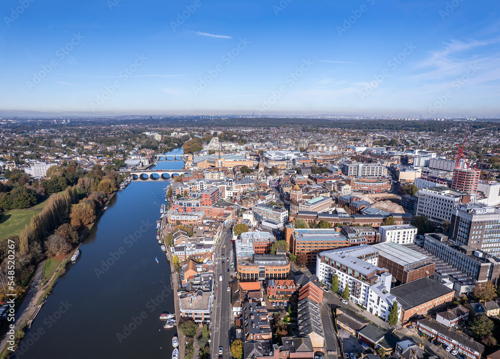 The drone aerial view of Thames River  running through the town centre of Kingston and Hampton Court Park, Bushy Par in the London Borough of Richmond upon Thames. 