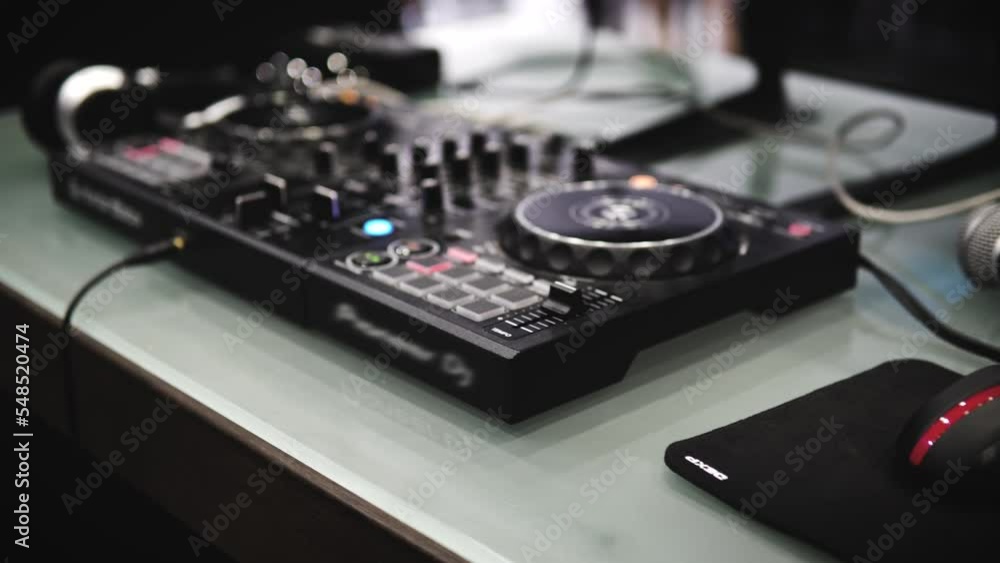 In selective focus Pro dj controller. The DJ console CD mp4 deejay mixing table music party in a nightclub In selective focus Pro dj controller. The DJ console CD mp4 deejay mixing table music party in a nightclub