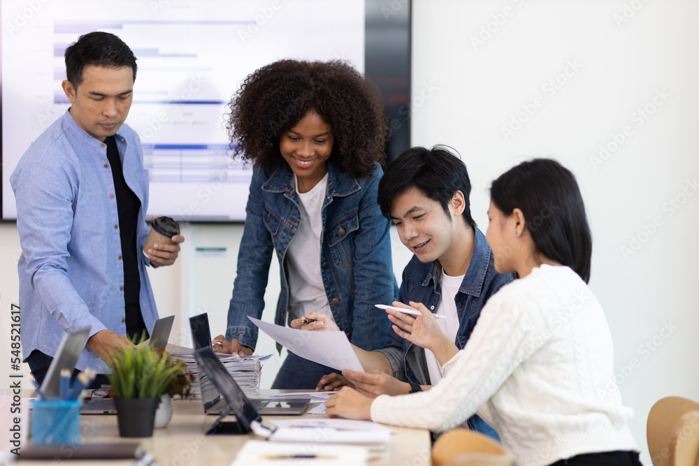 Fototapeta premium Young people meeting to discuss successful business projects in the office. Human relations and working with colleagues in the organization happily.