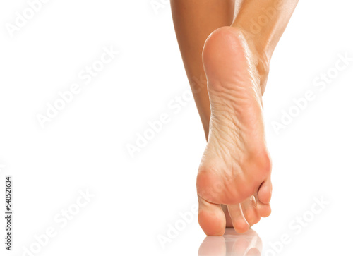 Foto Pretty woman legs and sole feet on white background
