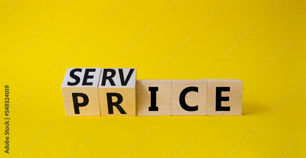 Service and price symbol. Turned wooden cubes with words service and price. Beautiful yellow background. Business and service and price concept. Copy space