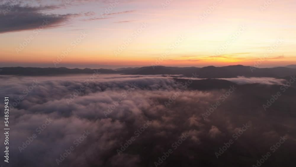 River of fog is flowing above the city during a beautiful sunset River of fog is flowing above the city during a beautiful sunset