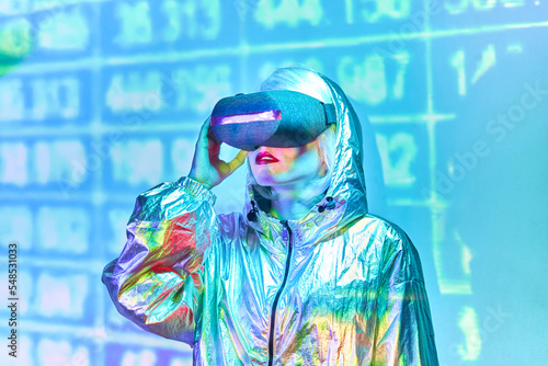 Woman in VR glasses wearing metallic shiny jacket