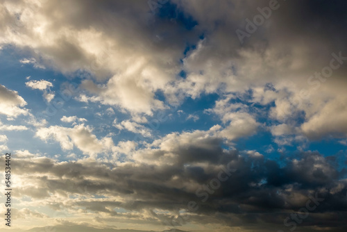 View of blue sky and white clouds colored by sun light