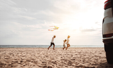Happy Family with car travel road trip. summer vacation in car in the sunset, Dad, mom and daughter happy traveling enjoy together driving in holidays, people lifestyle ride by automobile.