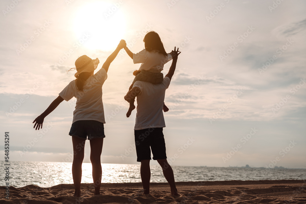 Fototapeta premium Happy asian family enjoy the sea beach at consisting father, mother and daughter having fun playing beach in summer vacation on the ocean beach. Happy family with vacations time lifestyle concept.