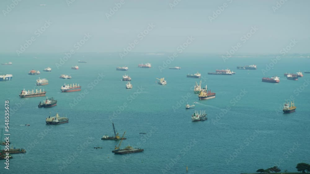 A fleet of cargo ships in the Singapore Straits, Asia A fleet of cargo ships in the Singapore Straits, Asia