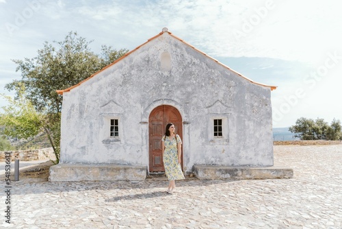 Low-angle of a white building and a female near scenic spot Miradouro das Portas de Rodao Portugal photo