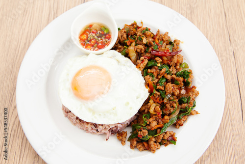 Rice with stir fried minced pork and basil topped with fried egg, Thai food called Pad Ka Prao Moo