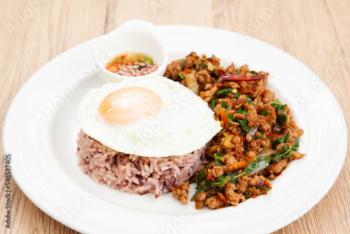 Rice with stir fried minced pork and basil topped with fried egg, Thai food called Pad Ka Prao Moo