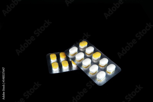 Sugar control tablet pills isolated on a black background