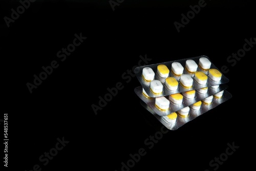 Sugar control tablet pills isolated on a black background