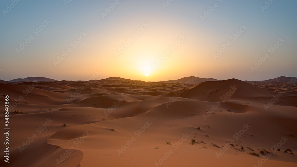 Beautiful sand dunes in the Sahara desert with amazing sunset sky - Sahara, Morocco
