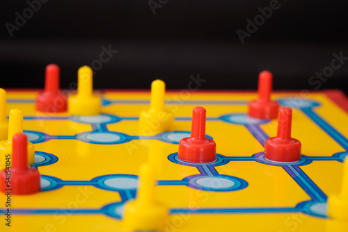 board game with red and yellow figures indoor. Intelligence and strategy board game.