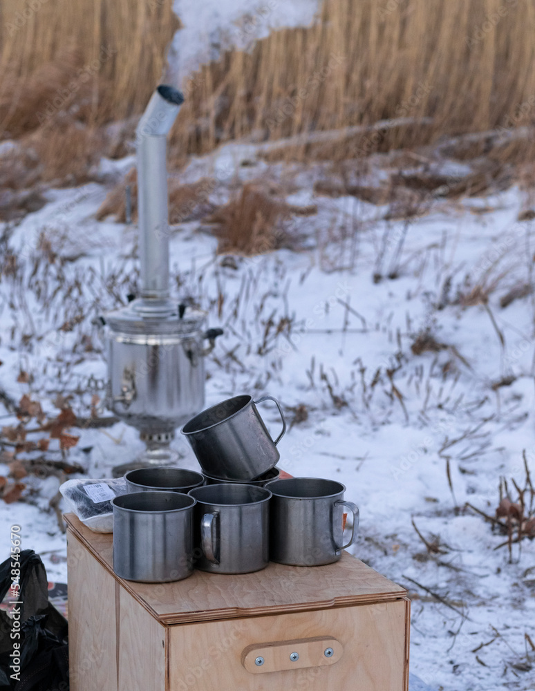 Russian glossy wood-fired samovar smokes in nature Russian glossy wood-fired samovar smokes in nature