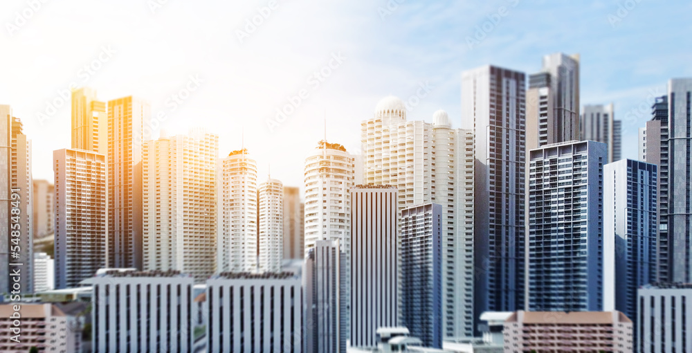 City building tilt-shift style with sun flare with blue sky day time. Real estate and property development. Innovative architecture. engineering structure and construction concept.