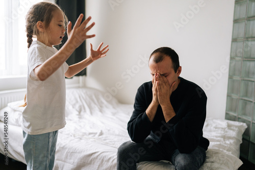 Naughty cute pre-teen child daughter scolding, raising voice, screaming and gesturing with arms to displeased father. Concept of dad-child problem in preteen years